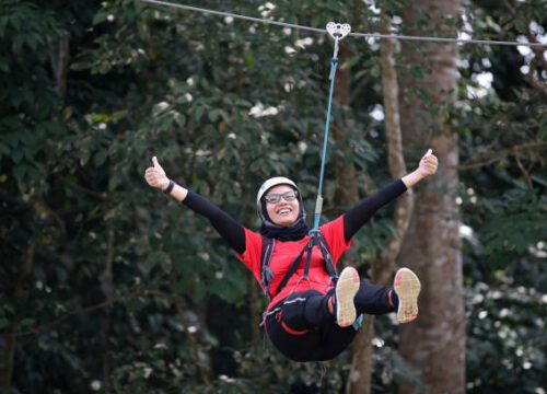 A Muslim woman enjoying flying fox extreme games.